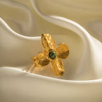 Gold plated flower open ring with green accent close-up