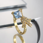 side profile of square blue-stone brass cocktail ring