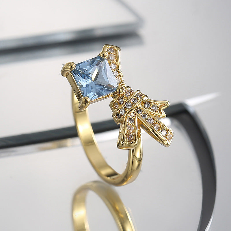 side profile of square blue-stone brass cocktail ring