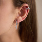 Silver tone clear stone hoop worn with a separate cuff