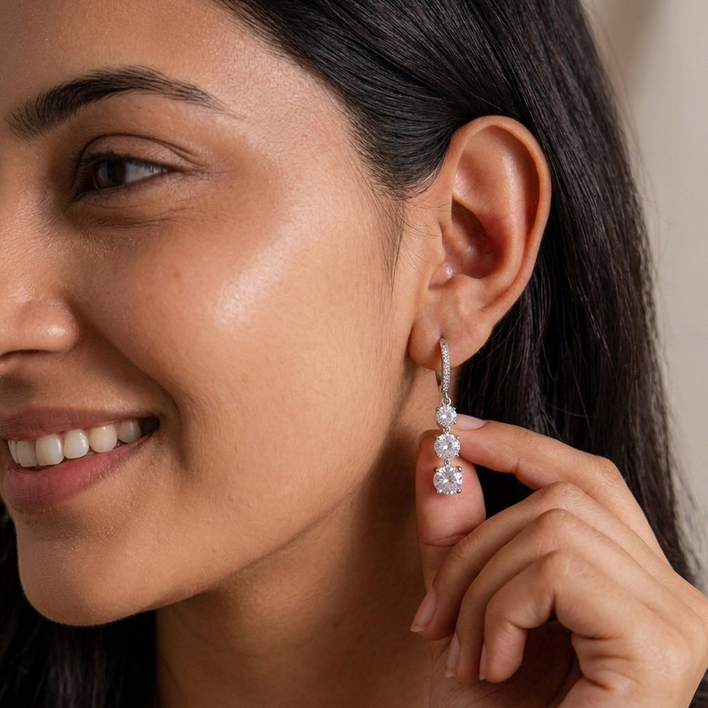Silver-tone three-stone drop earring shown on a model
