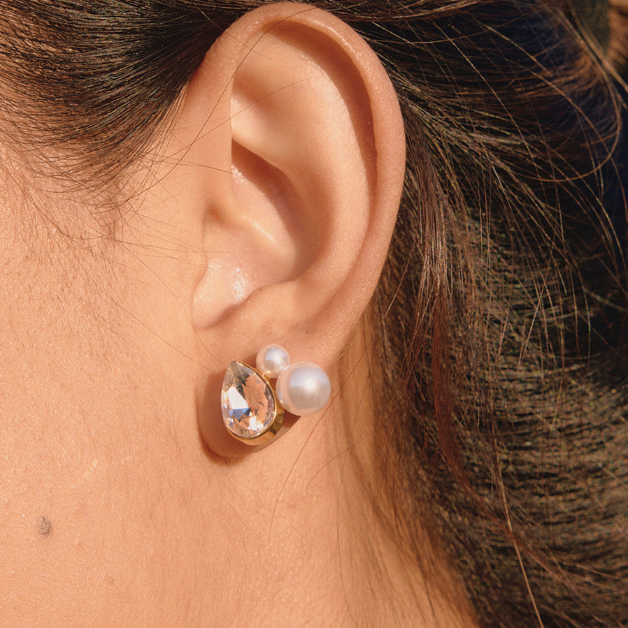 side view of clear pear-cut and pearlized bead stud earring