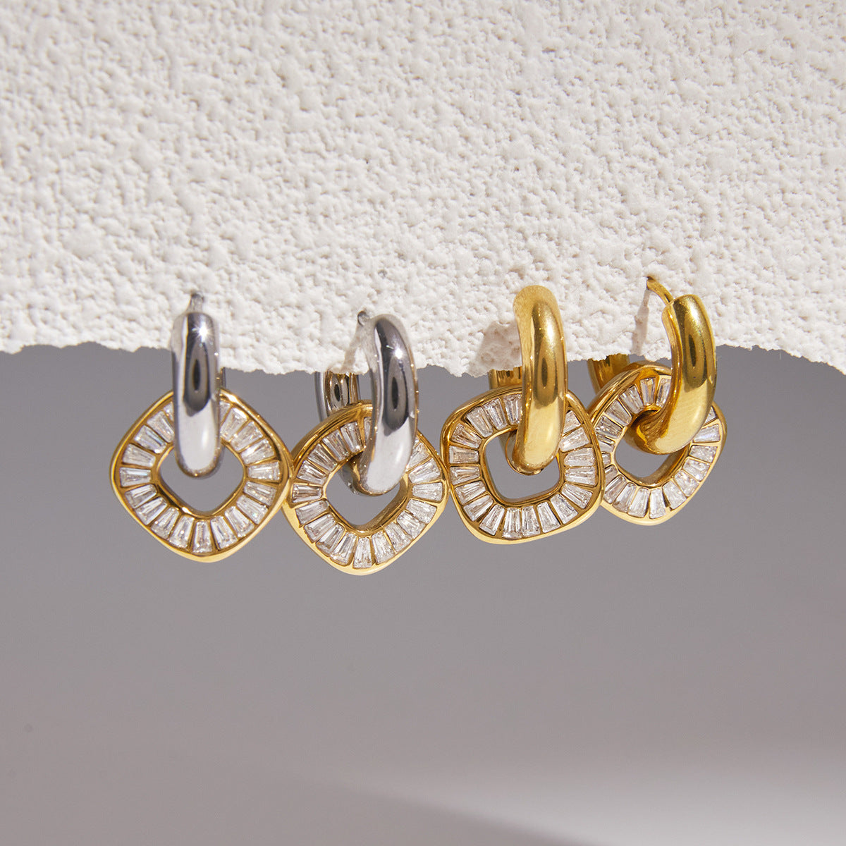 Gold and silver tone hoops with gold tone stone discs