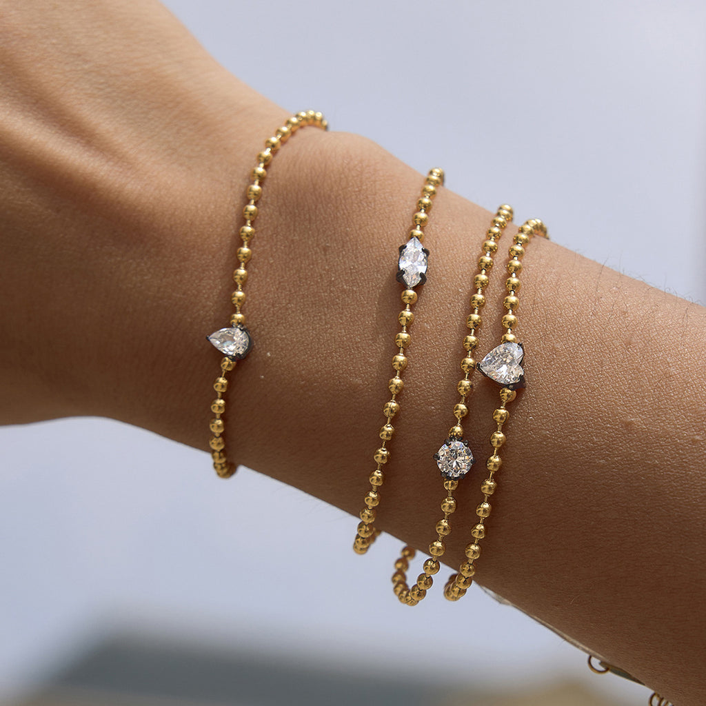 Solitaire bead-chain bracelets layered on a wrist