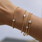 Solitaire bead-chain bracelets layered on a wrist