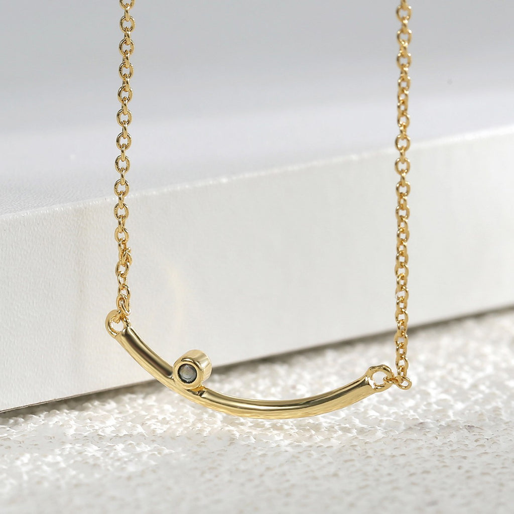 angled detail of the minimalist curved bar necklace