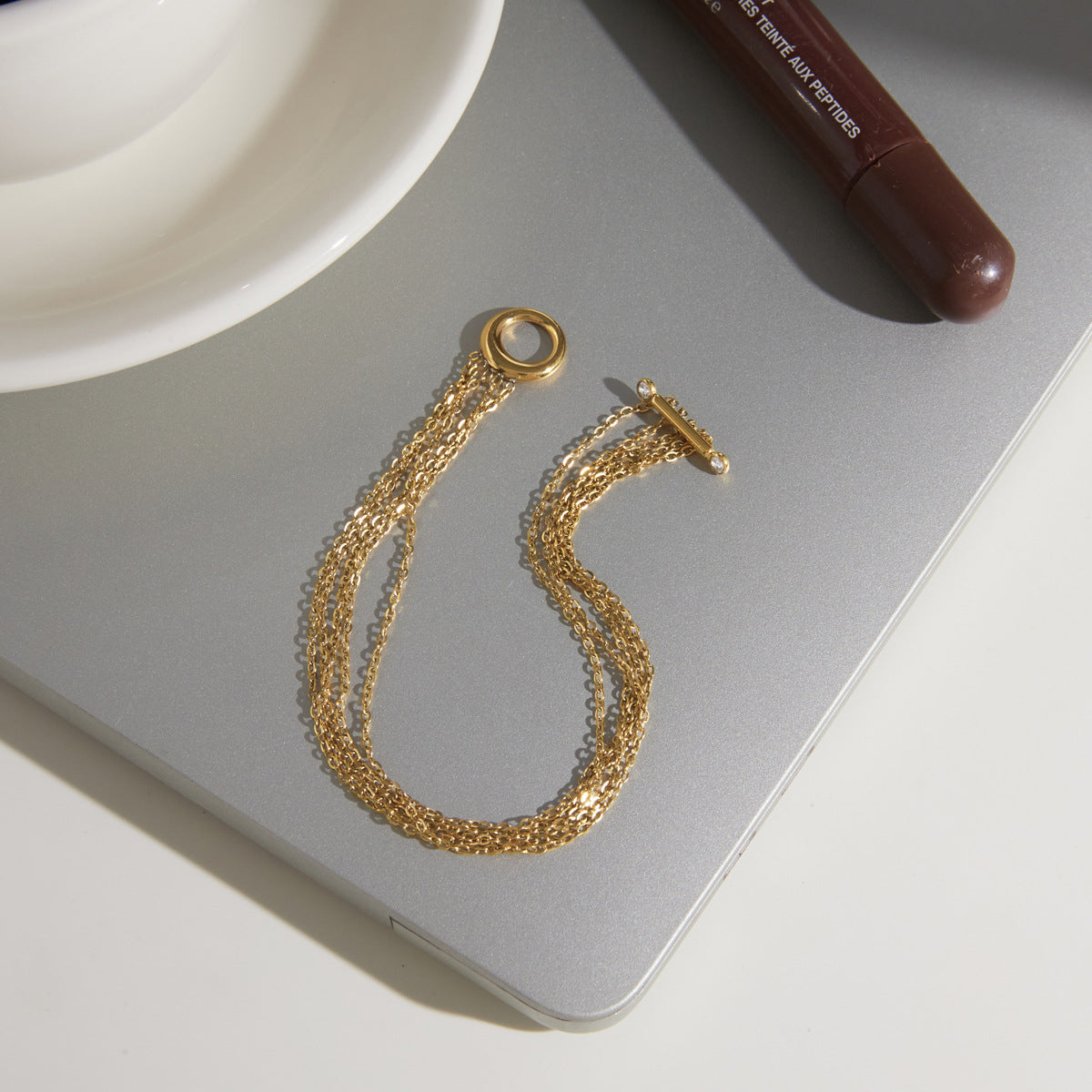 Multi-strand toggle bracelet laid open on a tray