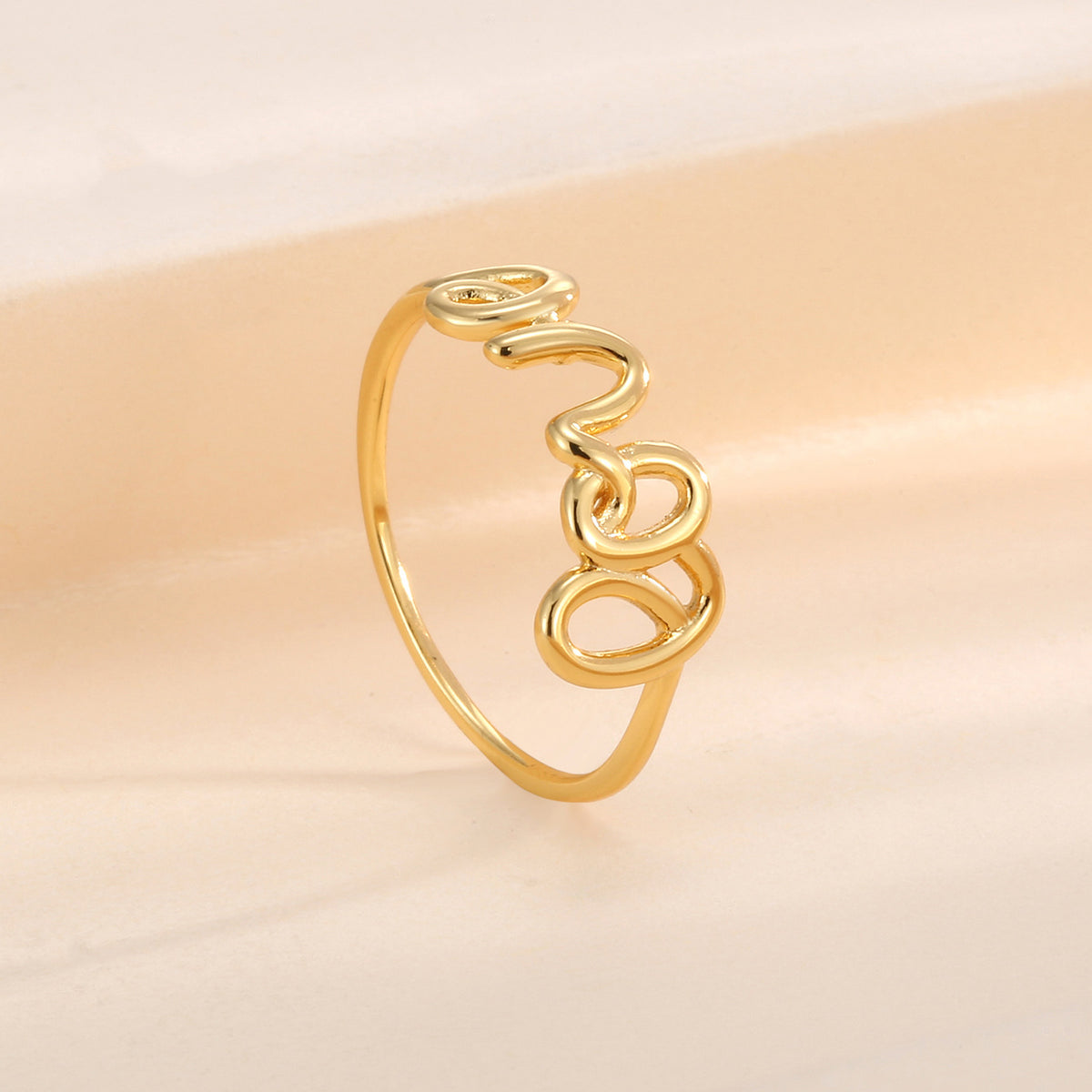 angled side view of the slim LOVE script band ring