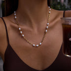 Long freshwater pearl station necklace worn at the neckline