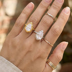 Two pear stone rings styled on fingers