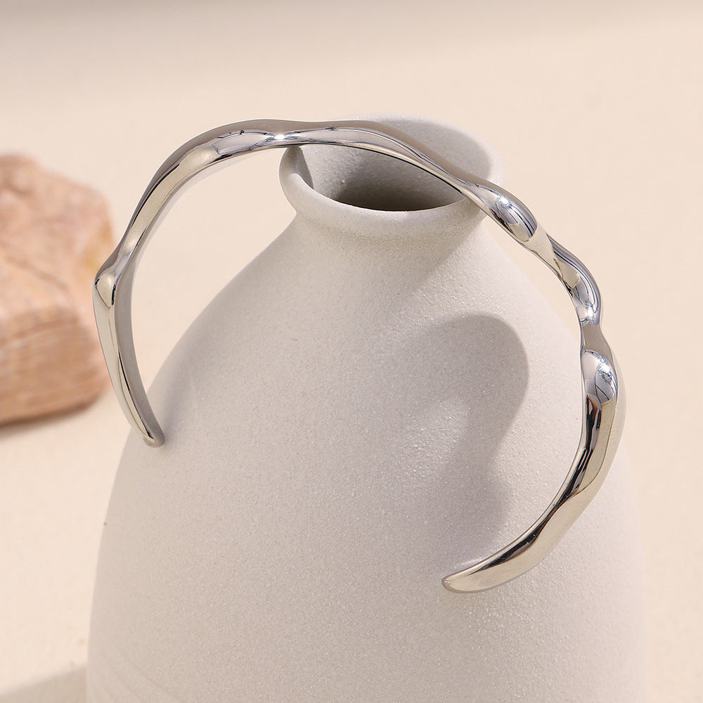 rear view of the silver-finish sculptural wave open cuff