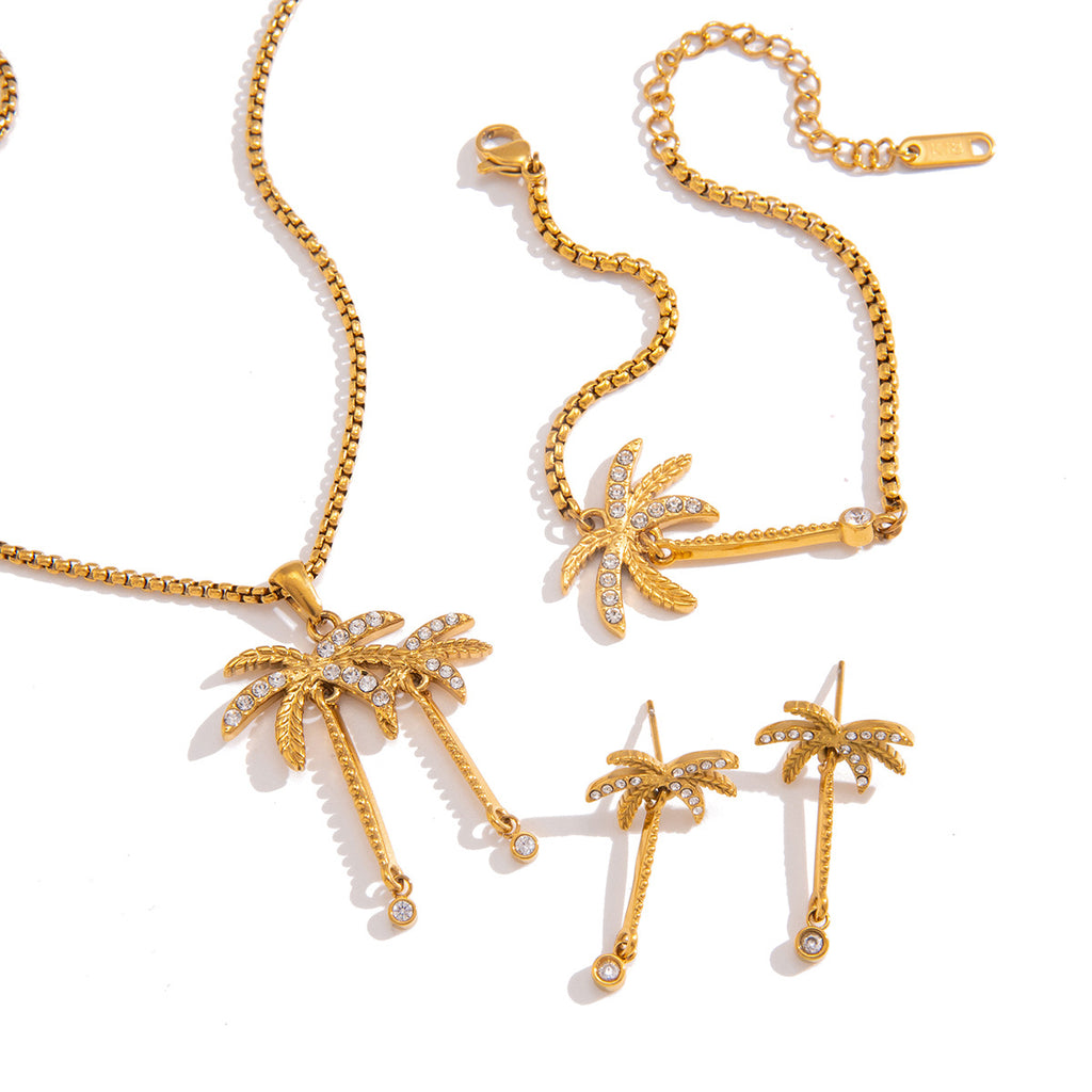 Gold-tone palm earrings necklace and bracelet on white