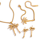 Gold-tone palm earrings necklace and bracelet on white