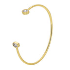 isolated gold plated cuff with bezel-style clear stone ends