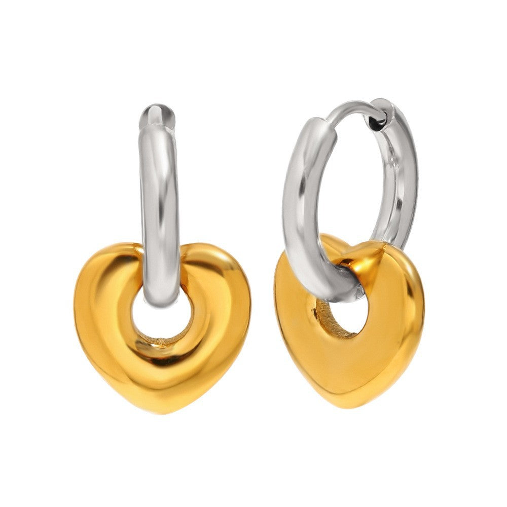 Gold tone heart charms hanging from silver tone hoops