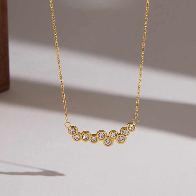 Gold tone round clear stone cluster close-up
