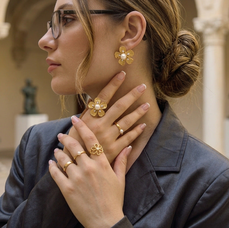 Gold tone floral ring and earrings styled on a model