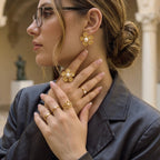 Gold tone floral ring and earrings styled on a model