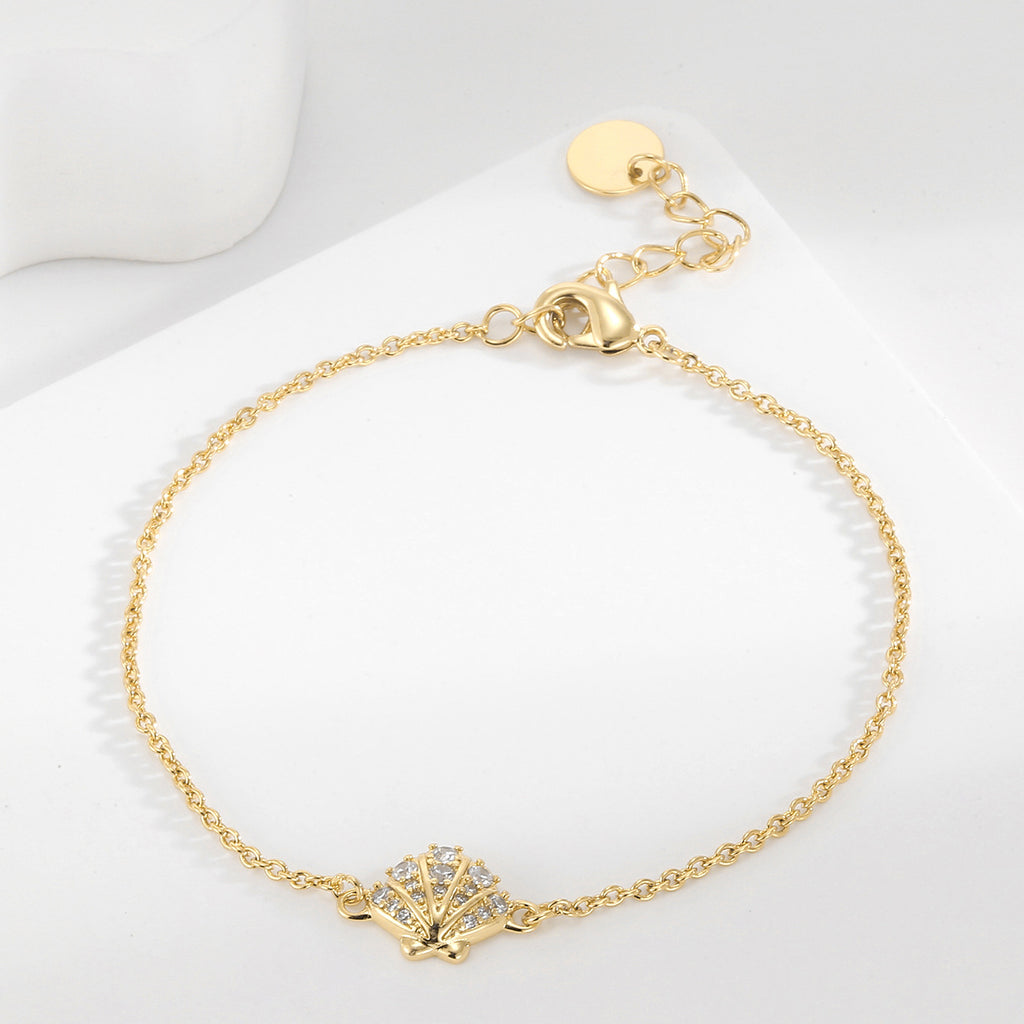 clear stone shell station bracelet arranged on a white display