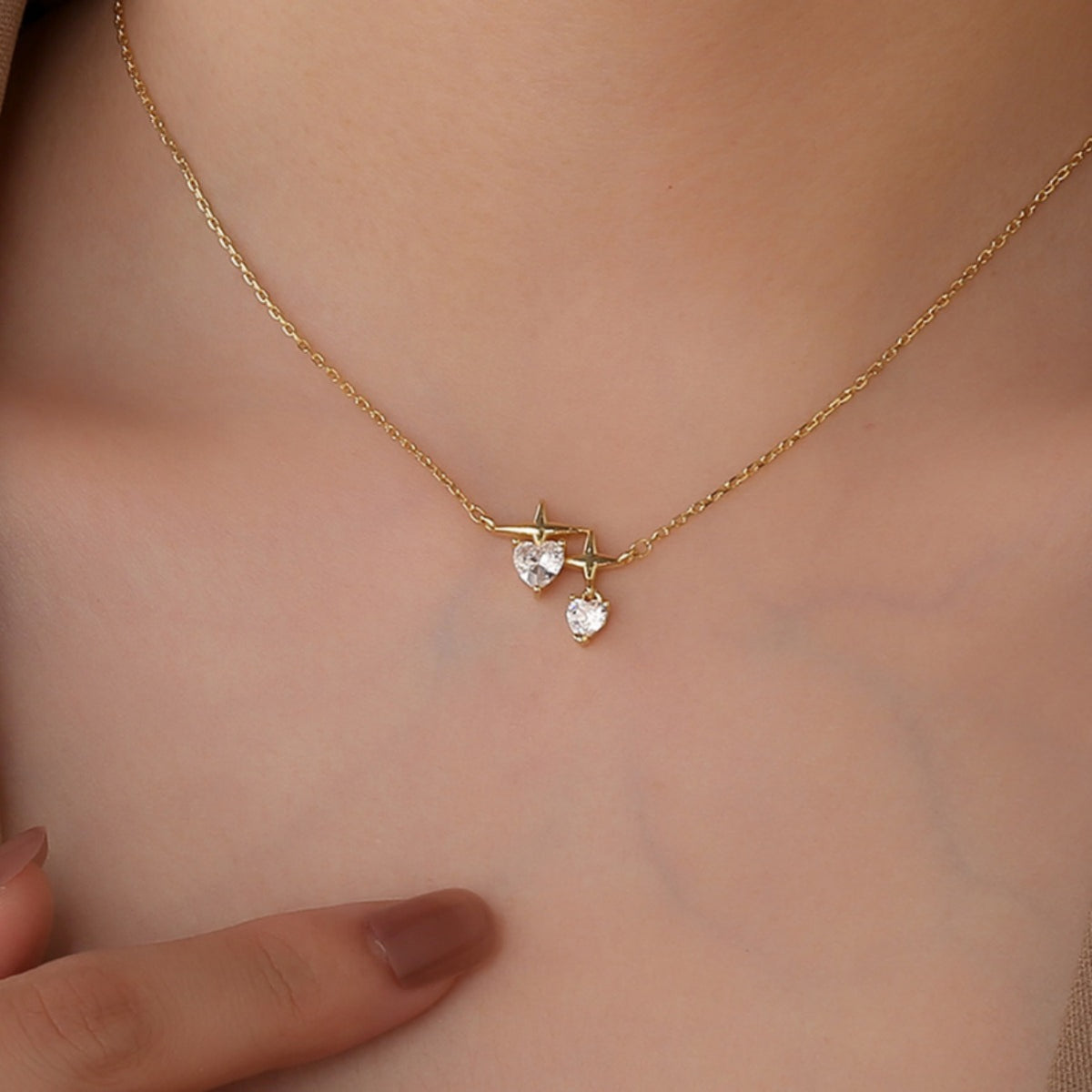 star and heart station necklace worn at the collarbone