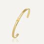 gold plated butterfly open cuff bracelet on a neutral background