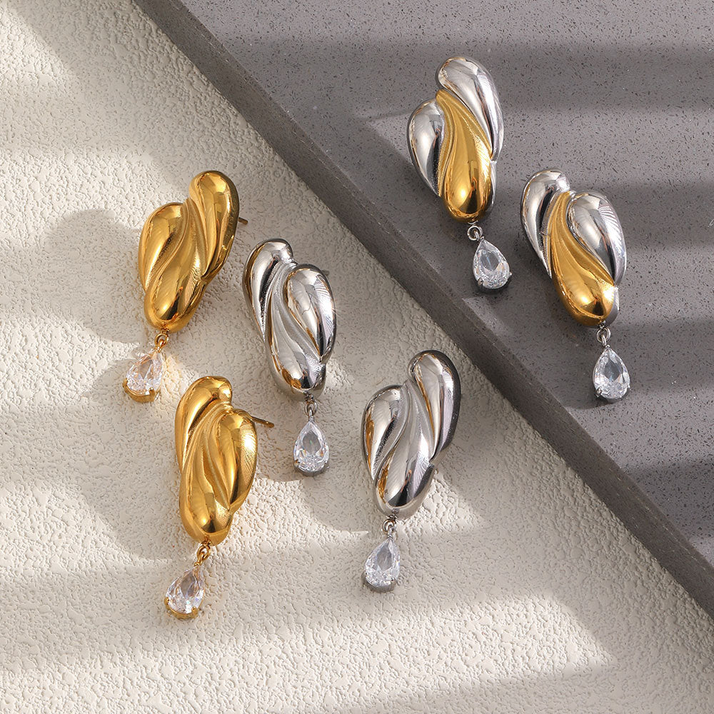 Gold tone silver tone and two-tone earring assortment on steps