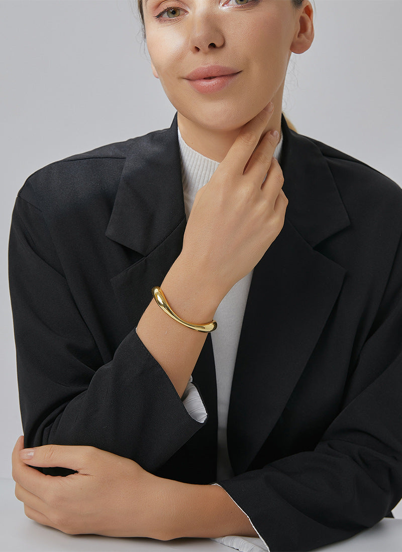 model wearing asymmetric gold plated open bangle