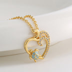 angled close view of blue resin turtle and open heart pendant