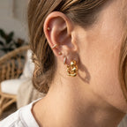 Twisted link hoop styled with additional ear jewelry