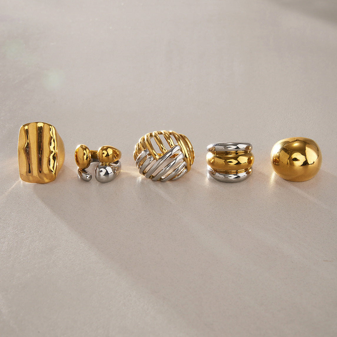 Five ring profiles lined up on a neutral background