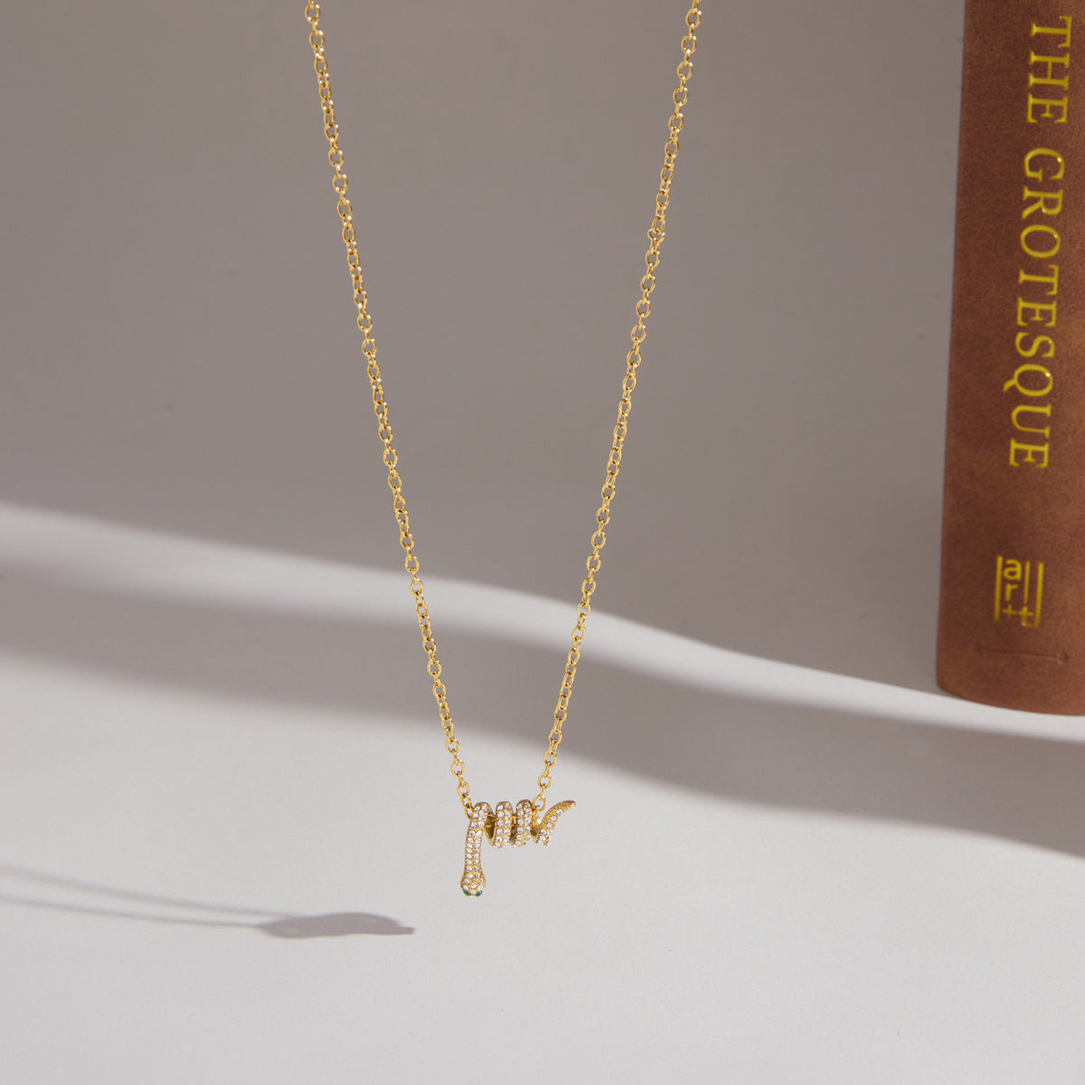 Single coiled snake pendant necklace on display