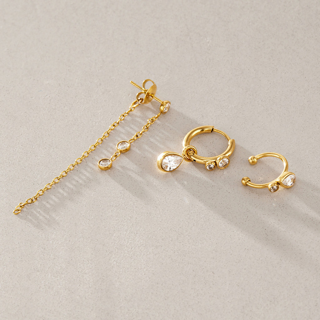 Chain stud pear-drop hoop and open cuff arranged together