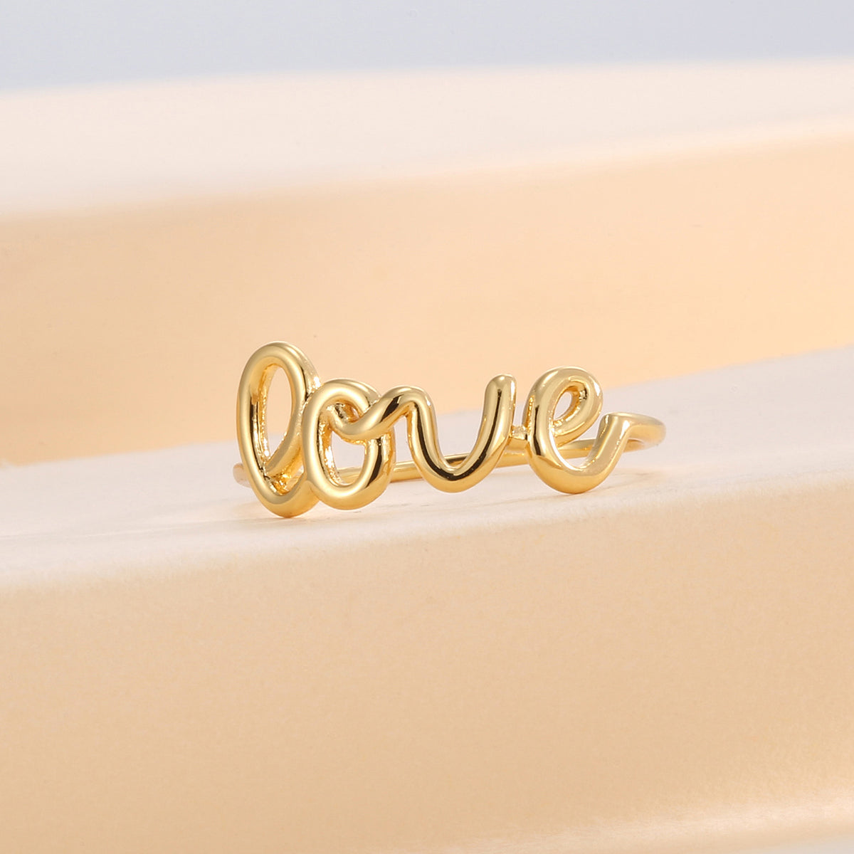 front view of the rounded open letter ring design