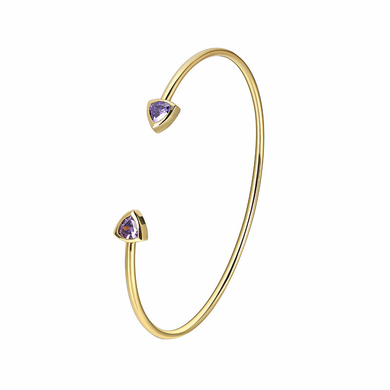 front view of brass open cuff with triangular purple stones