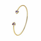 front view of brass open cuff with triangular purple stones
