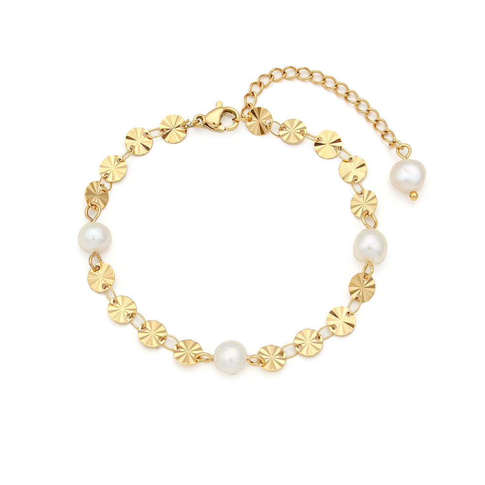 Gold-tone stainless steel sunburst disc bracelet on white