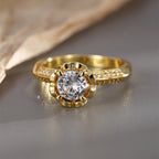 front view of round clear stone in a flower-like prong basket