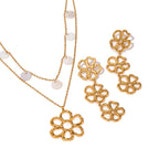 Triple flower earrings shown alongside a separate flower necklace