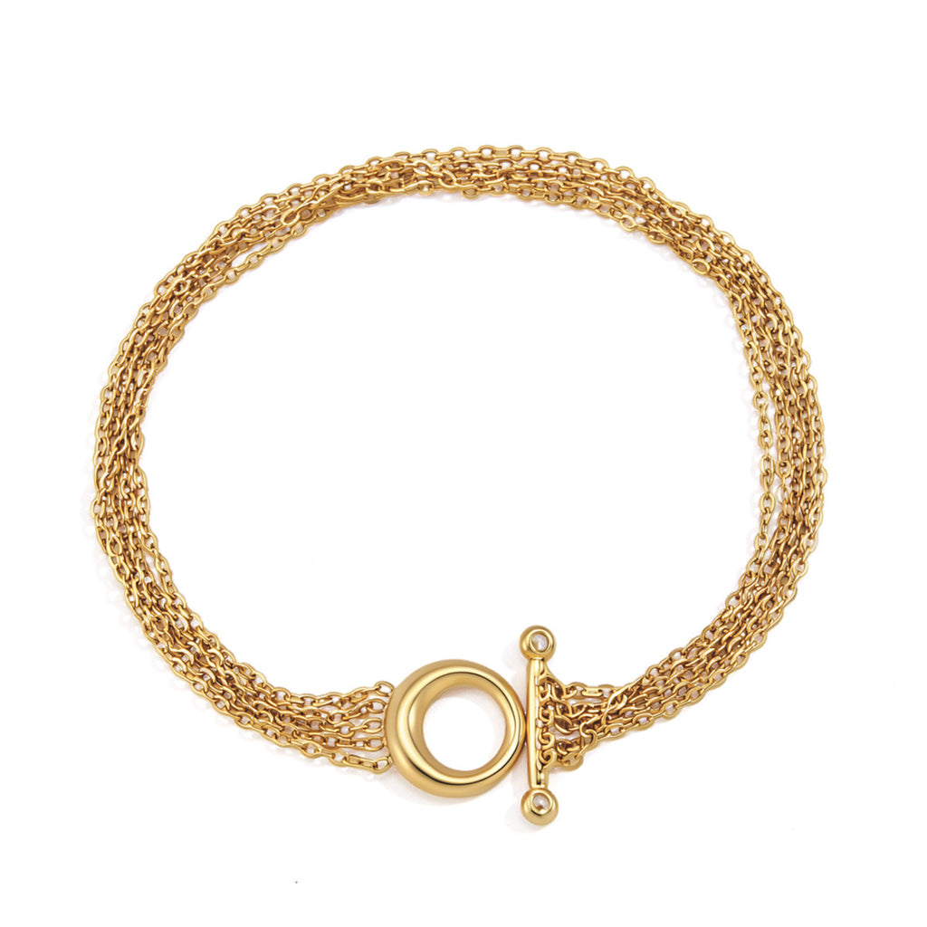 Fine-chain bracelet arranged in a circle on white