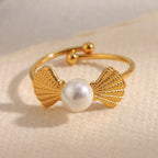 front view of ribbed shell motifs around an imitation pearl