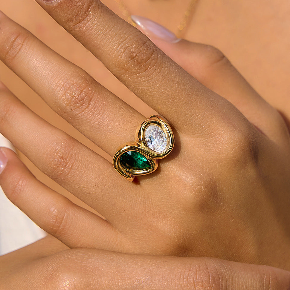Close-up of green and clear stones on finger