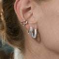 model wearing silver stainless steel square stone huggie earrings