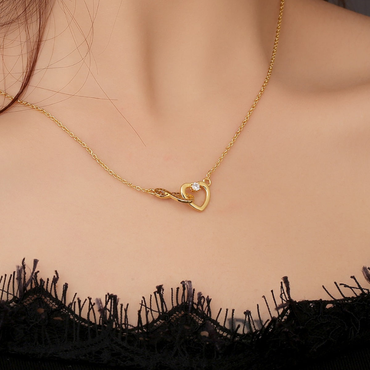 gold plated infinity heart chain necklace worn at the collarbone