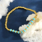 turquoise-color accent bracelet styled on navy fabric