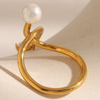 rear view of looping gold plated open ring and imitation pearl