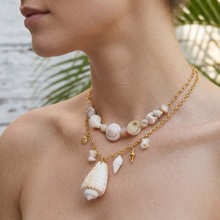 Mixed shell necklace designs shown at neckline