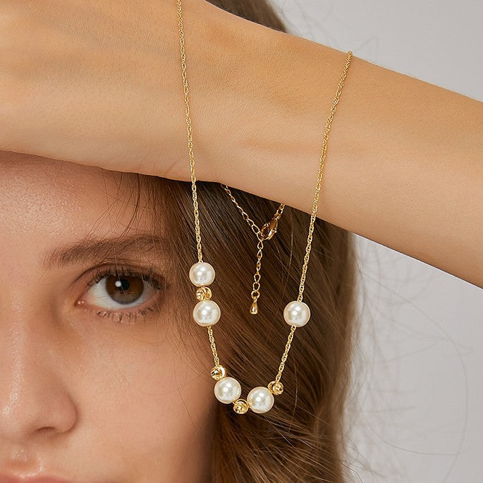 white shell pearl necklace shown with its extension chain