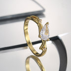 angled pear-cut clear stone ring with curved bypass detail
