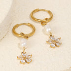 stainless steel pearl flower huggie earrings styled on stone