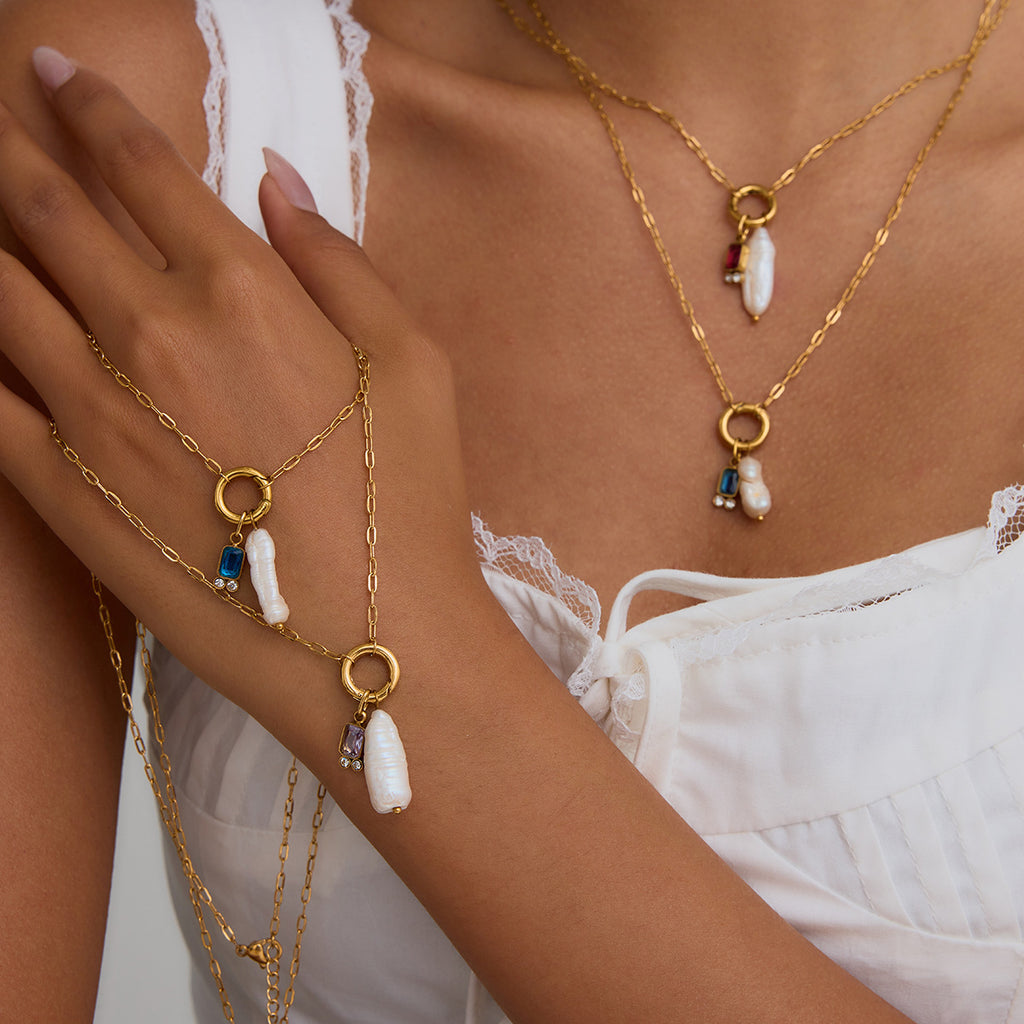 Gold-tone stainless steel pearl drop necklace and ring collection worn view